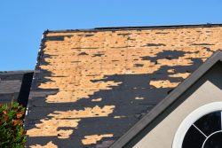 Wind,Damaged,House,Roof,With,Missing,Asphalt,Shingles,After,Hurricane